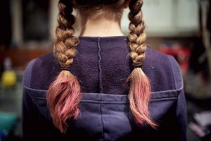 Brunette girl with plaited hair with pink tips